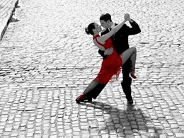 Couple dancing Tango on cobblestone road